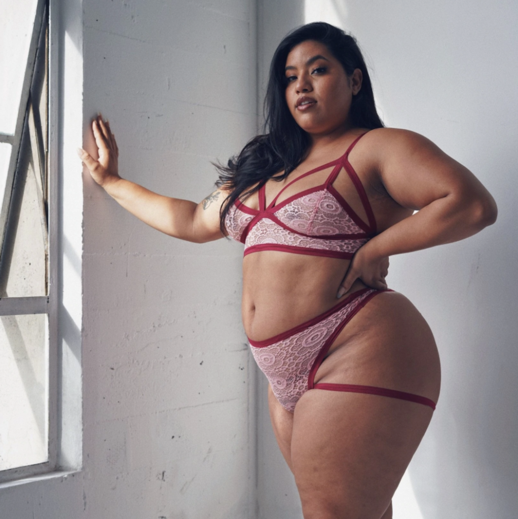 Good Bodies' Amazing Places for Plus-Size Lingerie - Cantiq LA Pink Lacy Set with red trim on model with long black hair