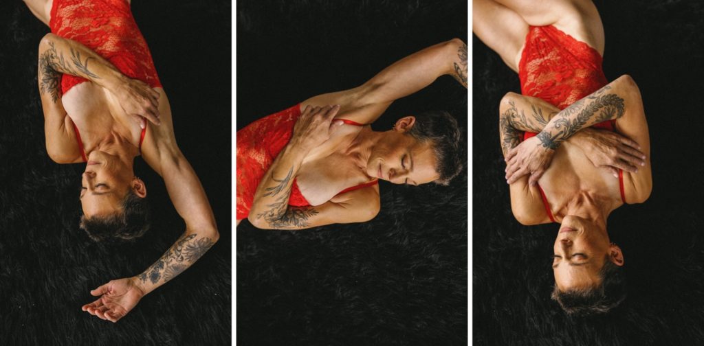 Individual boudoir photos, woman in red bodysuit posing black textured background, laying down but pictured from above