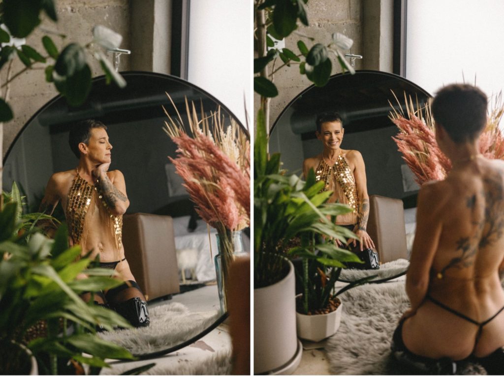 Individual boudoir photos, woman facing circle mirror in gold sequin top, thong, and black leather boots